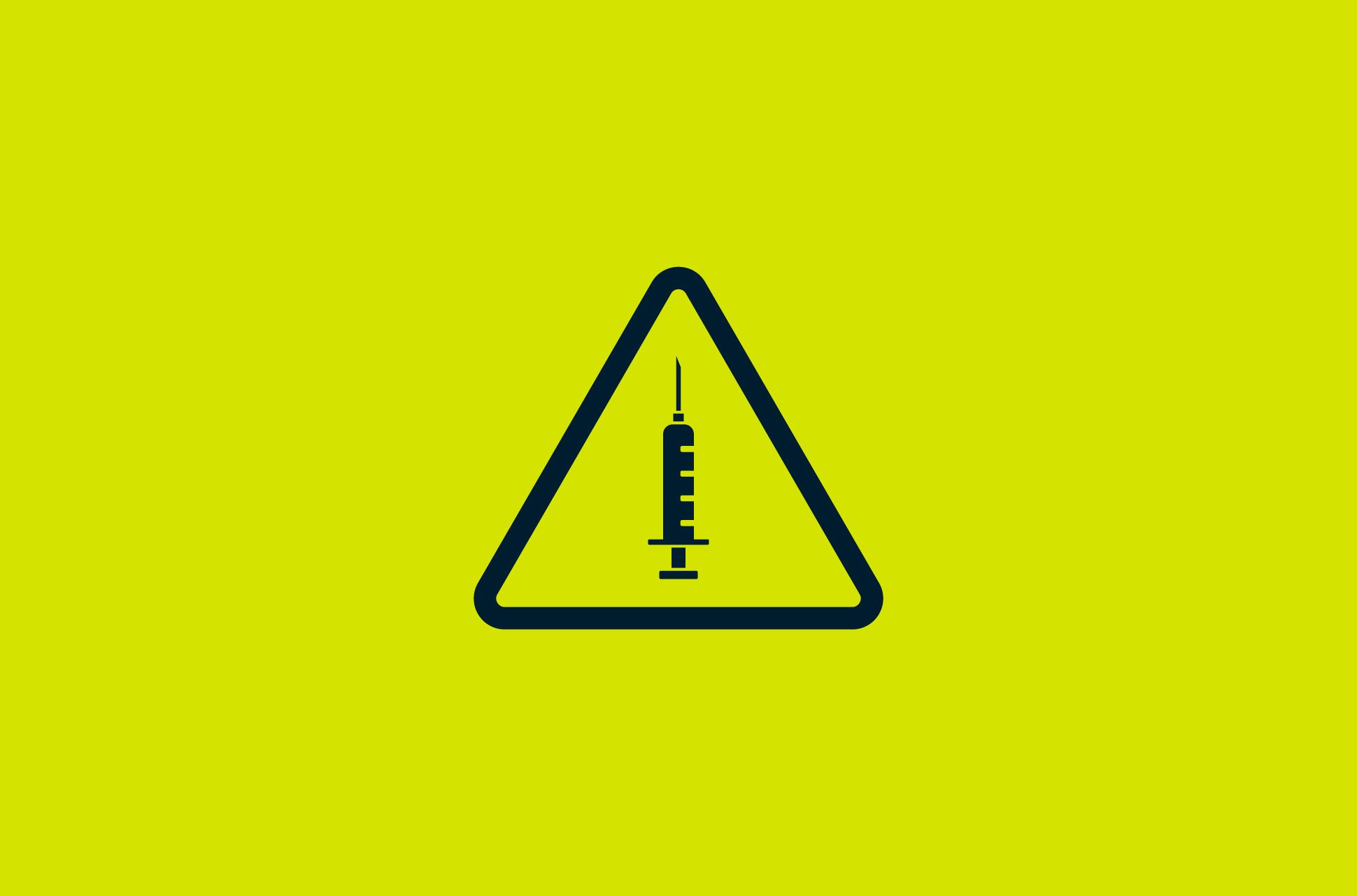 A warning sign with a syringe in the middle.
